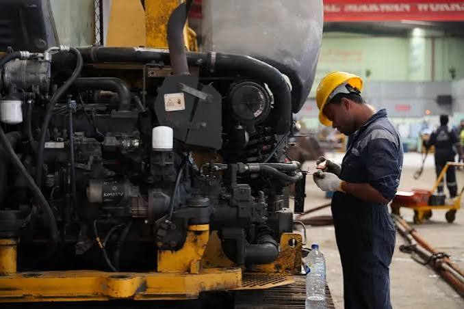 Used excavator undergoing mechanical inspection